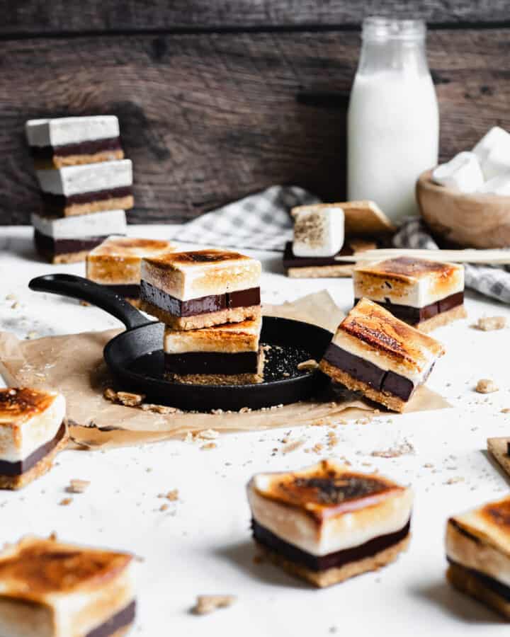 smores bars scattered across the scene. two are stacked in the middle.