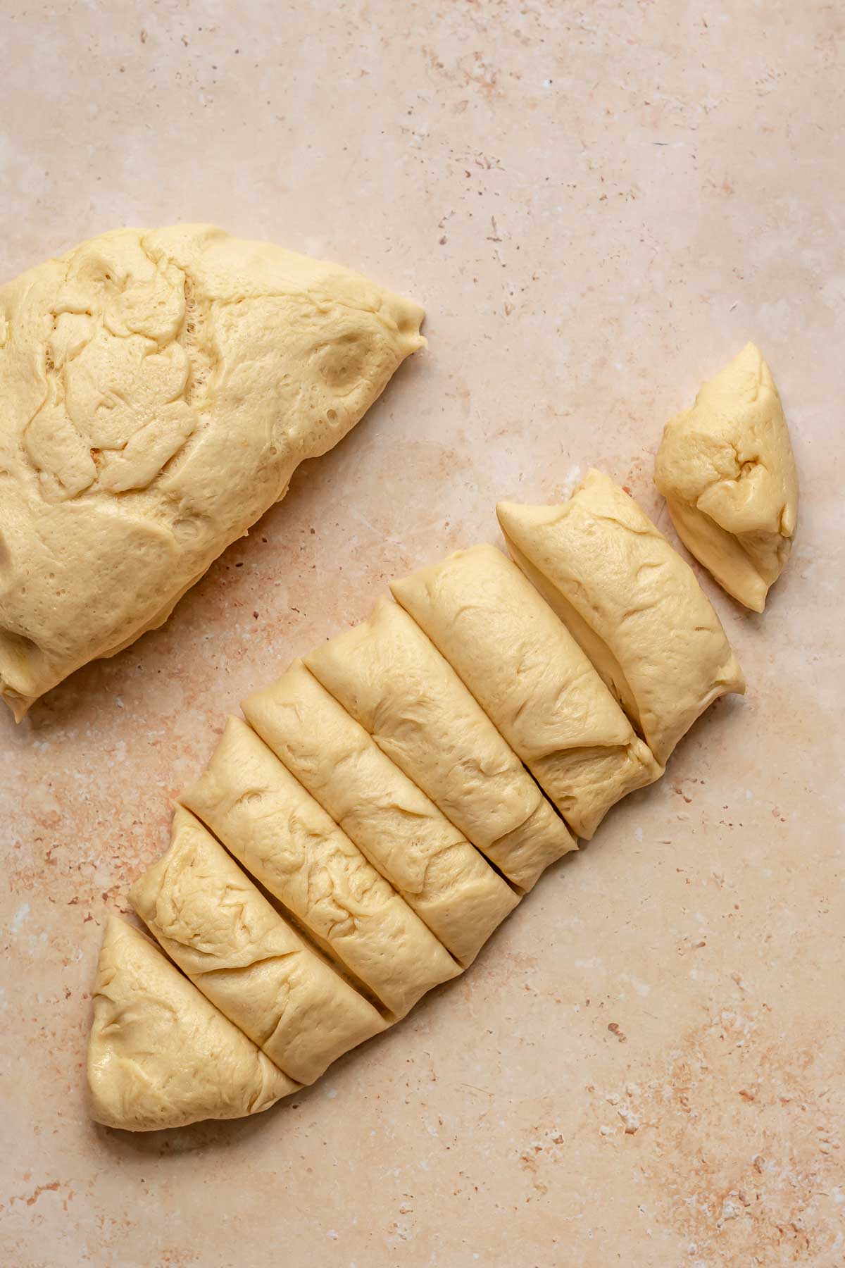 Brioche dough separated on a counter.