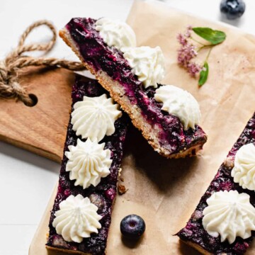 Blueberry pie bars laying against each other on a cutting board
