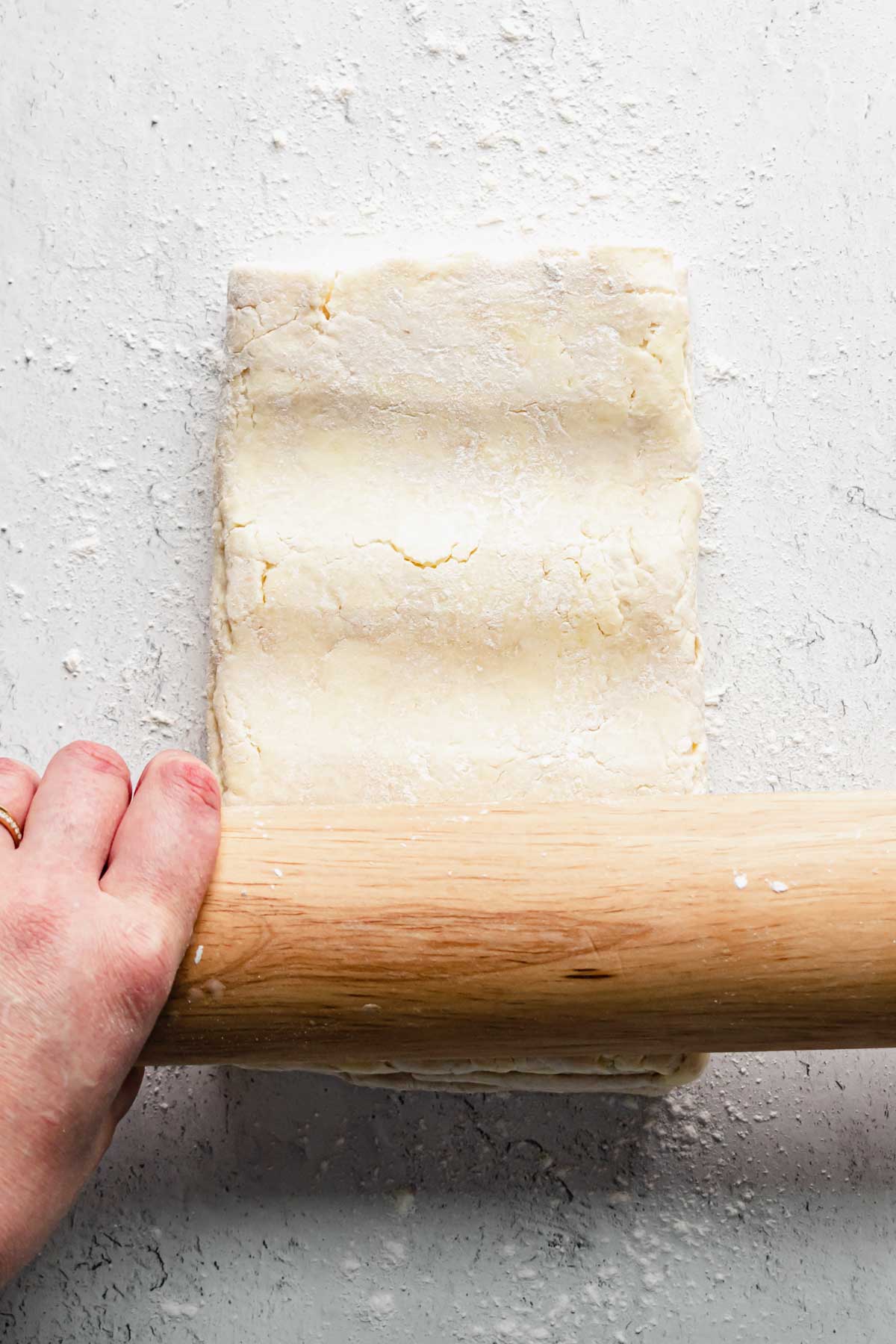A rolling pin makes indents into the dough before rolling.
