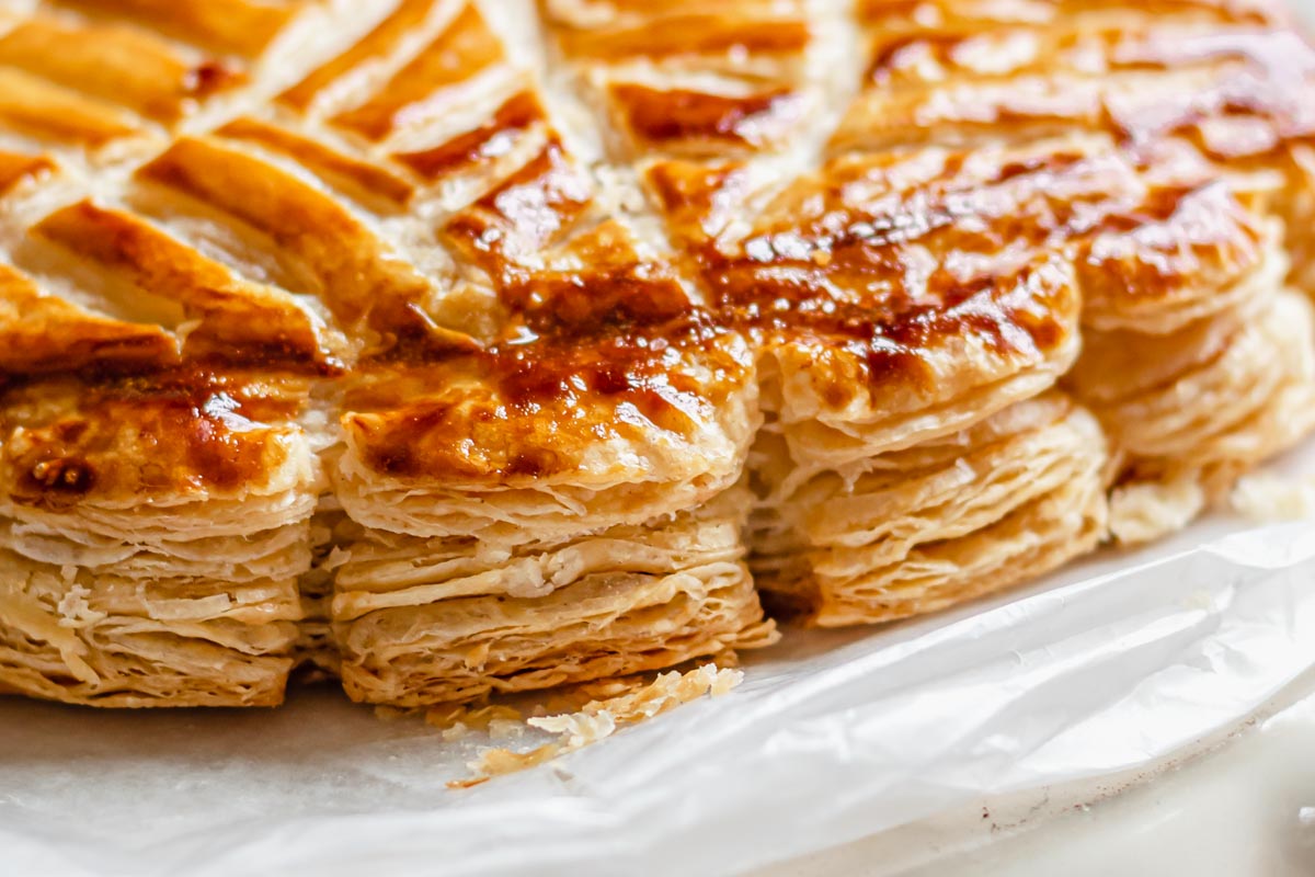 The flaky edges of baked rough puff pastry.