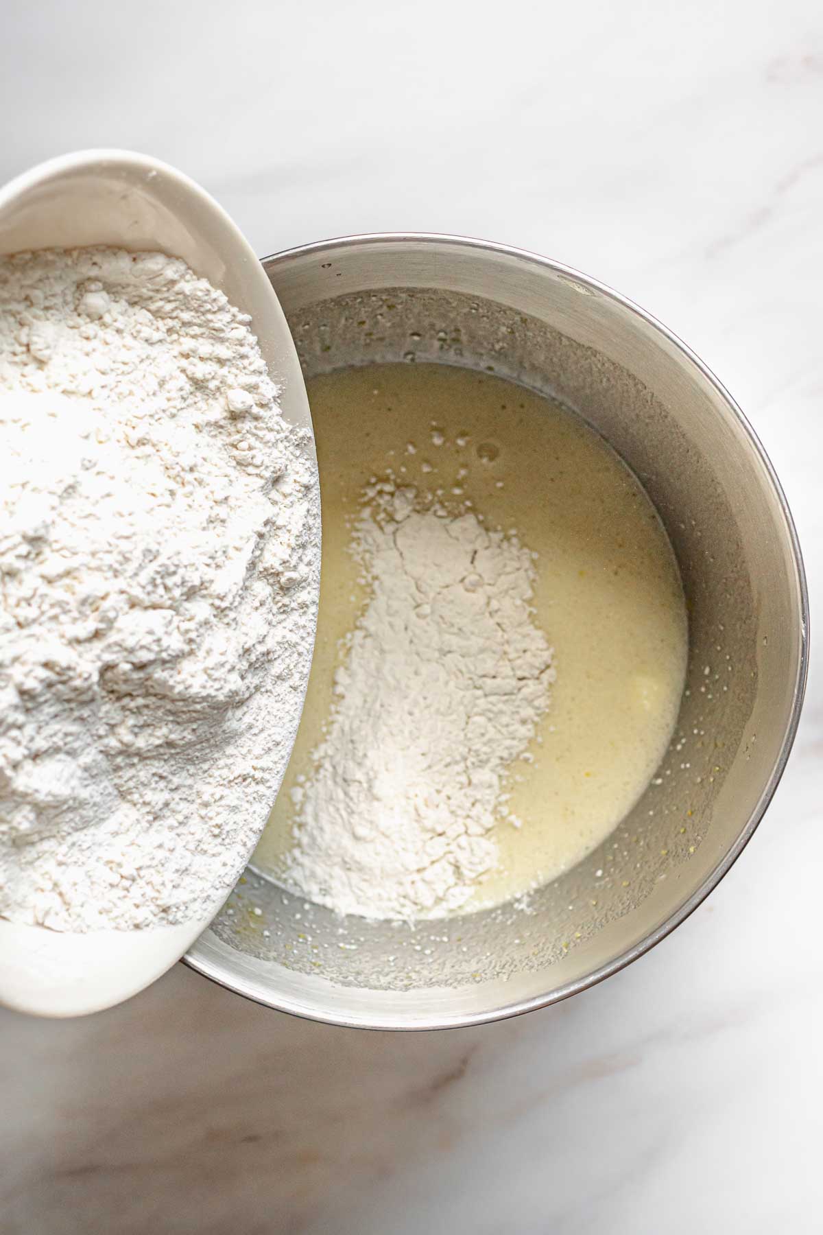 Dry ingredients being poured into the batter.