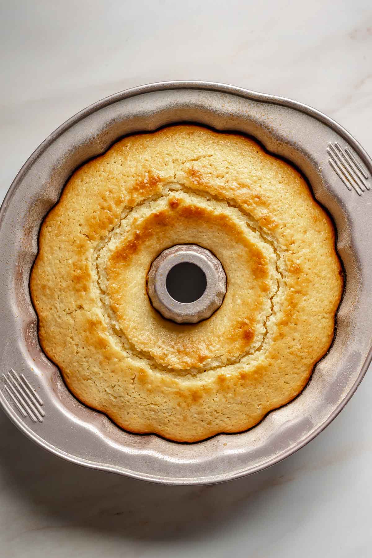 Fully baked lemon ricotta cake in a bundt pan.