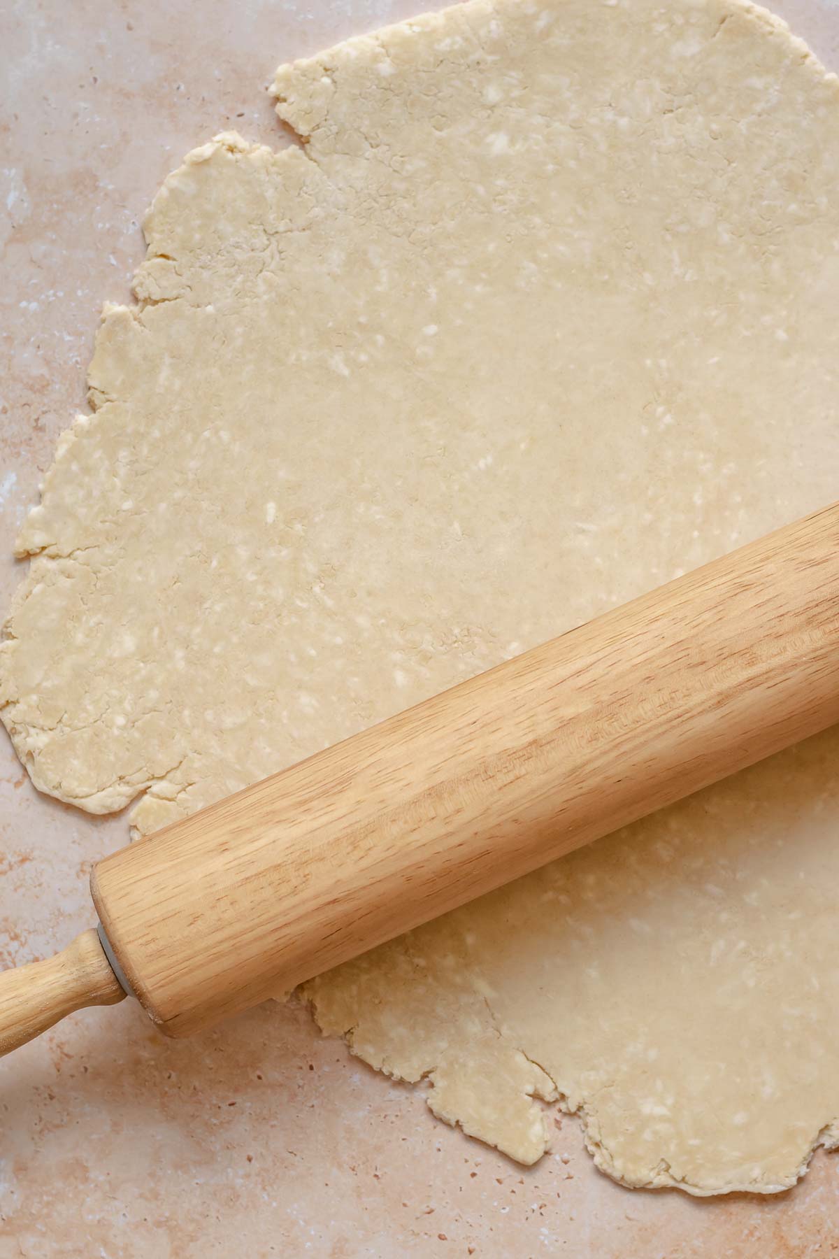 A rolling pin rolls out pie crust.
