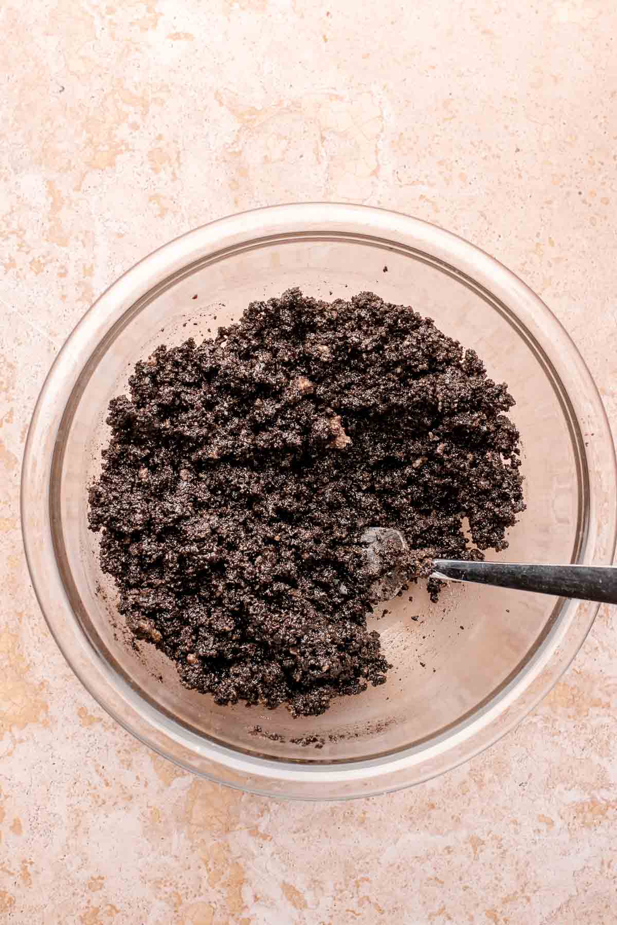 Oreo crumbs in a bowl with a fork.