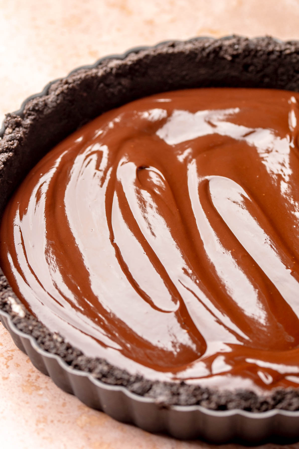 Chocolate ganache spread into a chocolate tart crust.