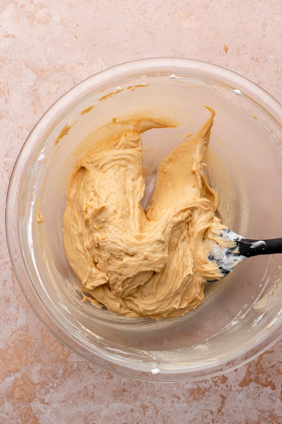 Fluffy peanut butter filling in a bowl with a spatula.