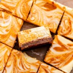 Sliced pumpkin cheesecake bars. One sits on its side.