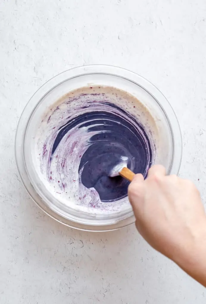 Purple color comes through the heavy cream as the blueberry ganache is stored together