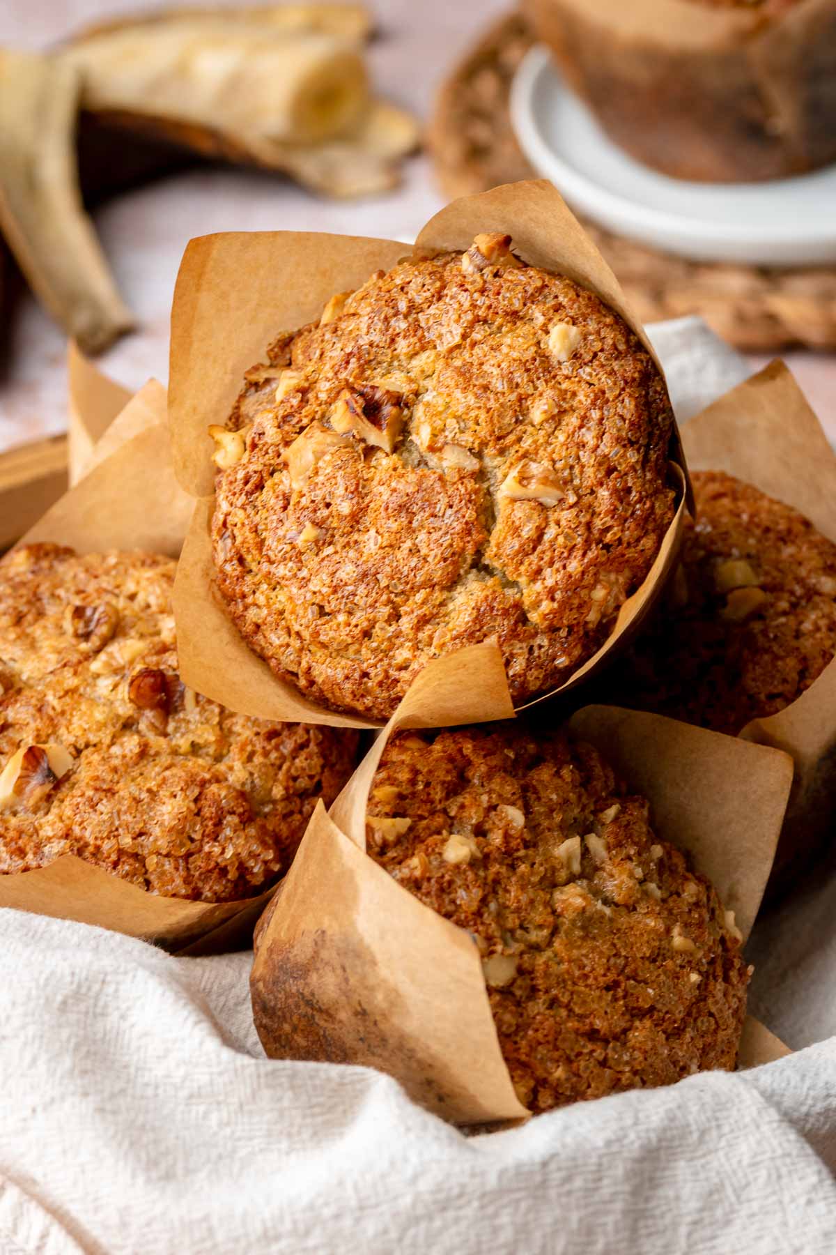 A heap of banana muffins with liners on.