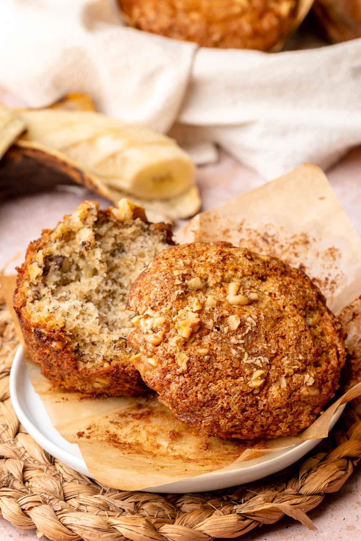 A banana nut muffin with the top removed on a plate.