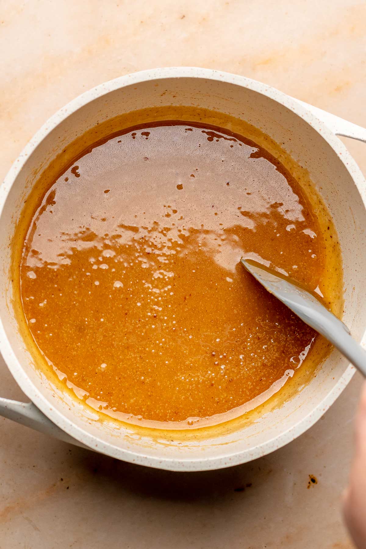 Apple cider caramel in a pot.