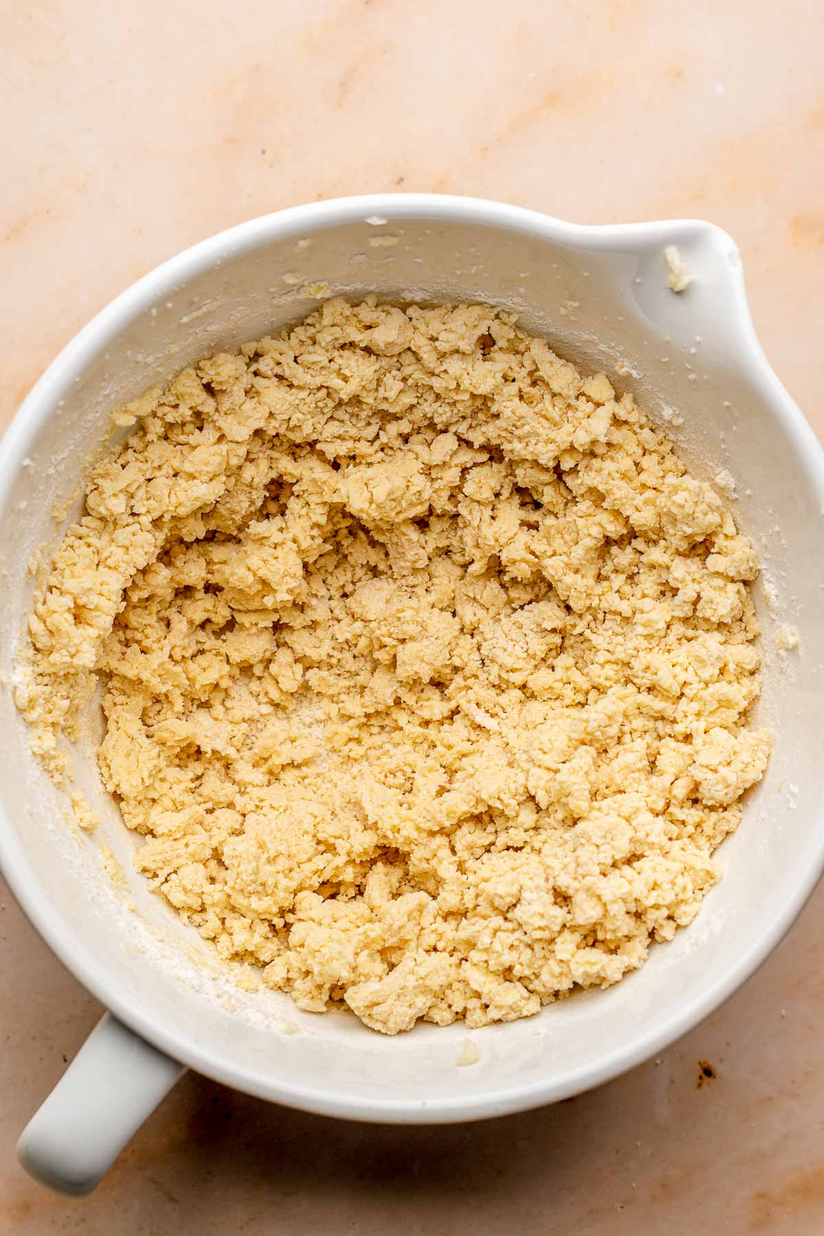 Crumbly cookie dough in a bowl.