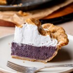 A slice of purple sweet potato pie on a plate.