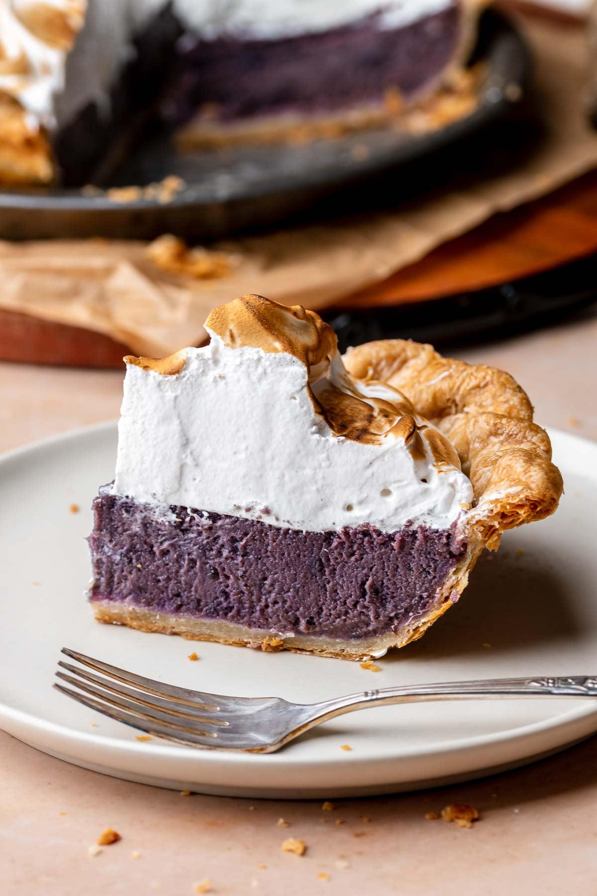 A slice of purple sweet potato pie on a plate.