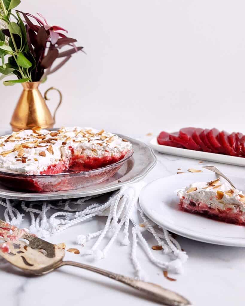 Frozen Cranberry Pie with a slice on a plate next to the pie