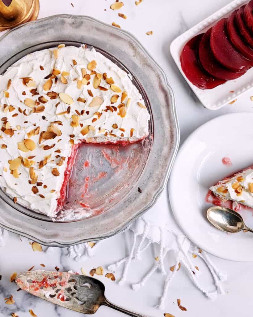 Top down photograph of the frozen cranberry pie with a slice on a plate