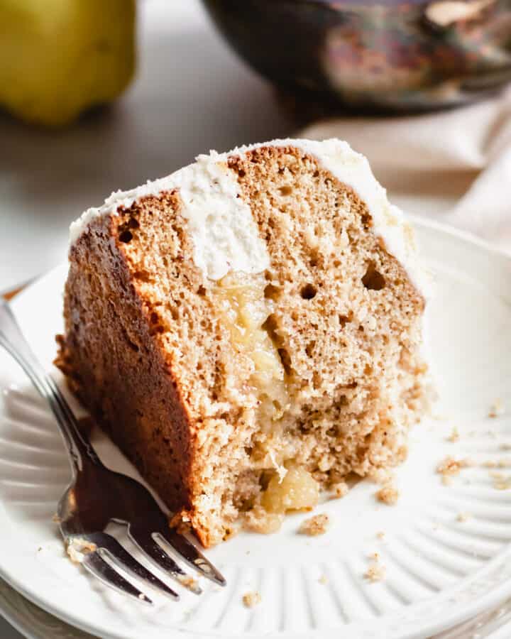 Slice of Pear Spice Cake on a plate with a bite removed