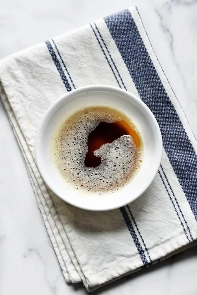 Overhead photo of deep brown butter in a bowl, in liquid form.