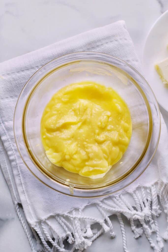 Lemon curd in a bowl after passed through a sieve.