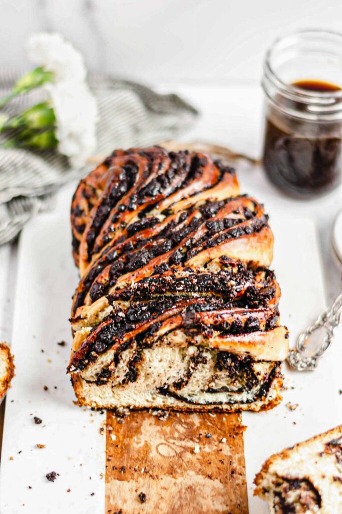 A slice is removed to show the center swirls of the chocolate espresso babka.
