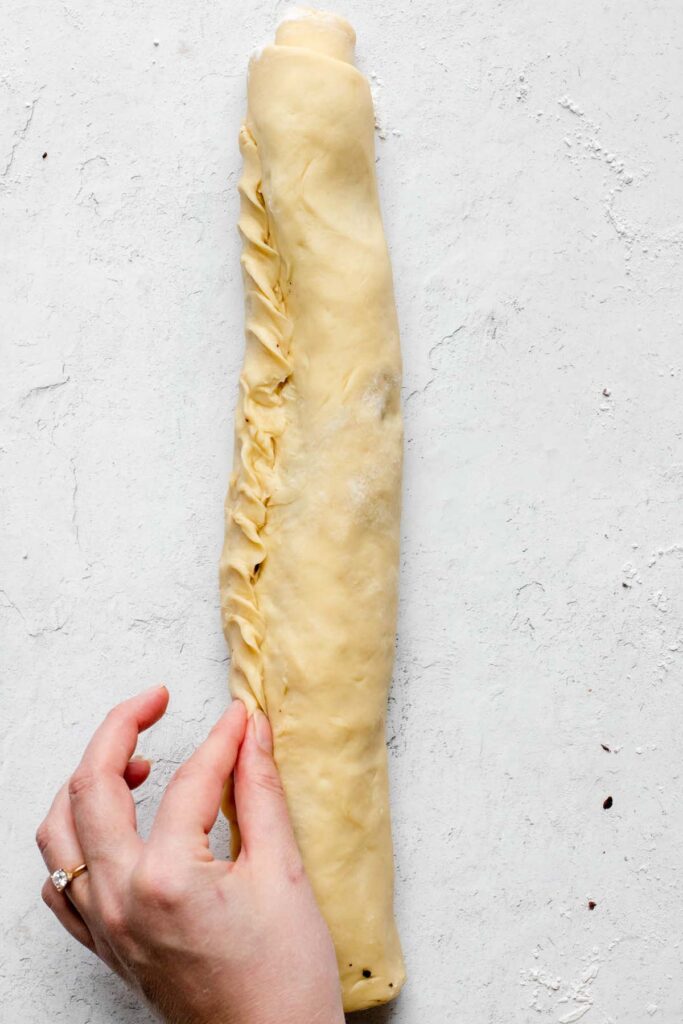 The dough gets pinched together to seal the edges.
