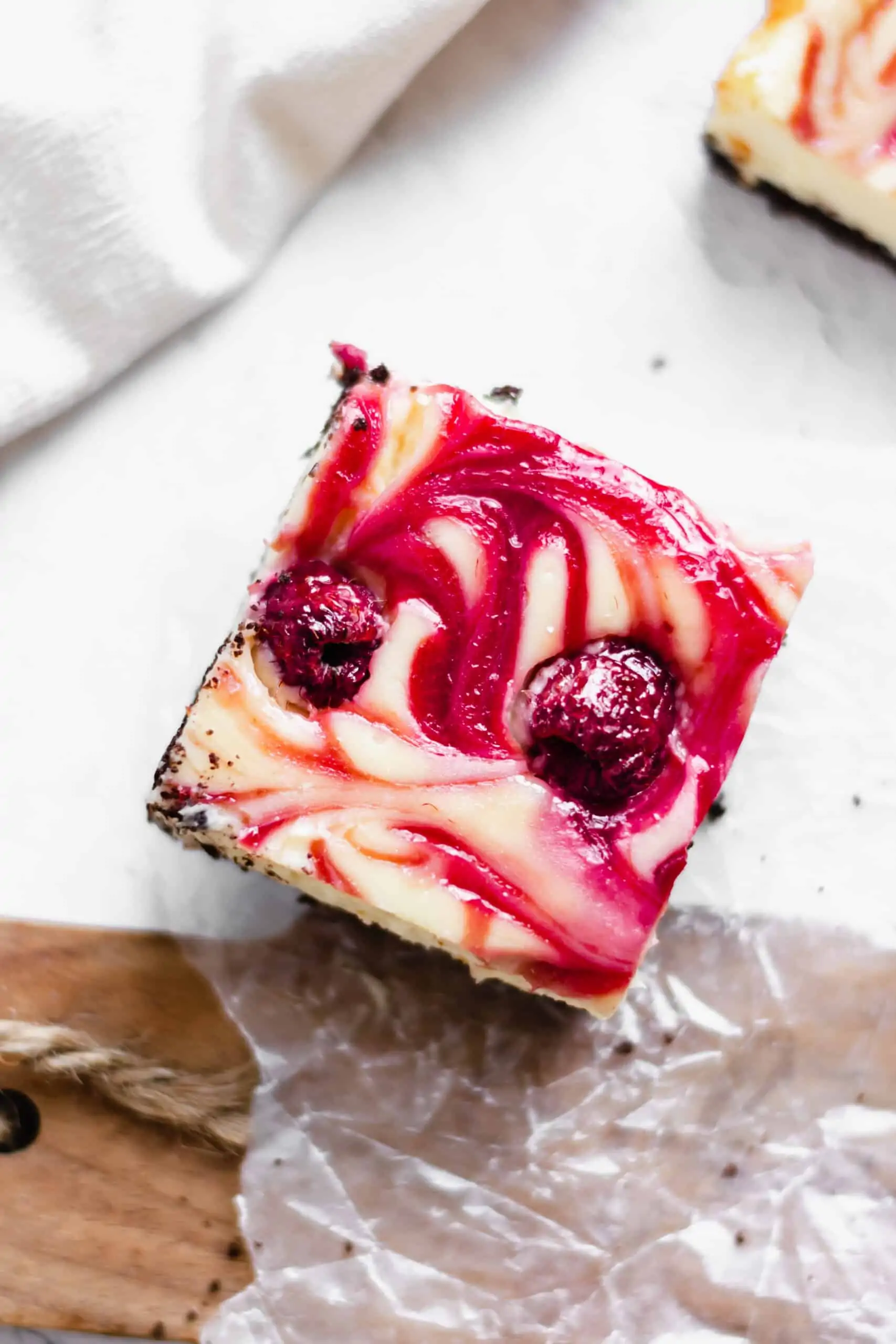 Overhead shot of one slice of raspberry white chocolate cheesecake bar