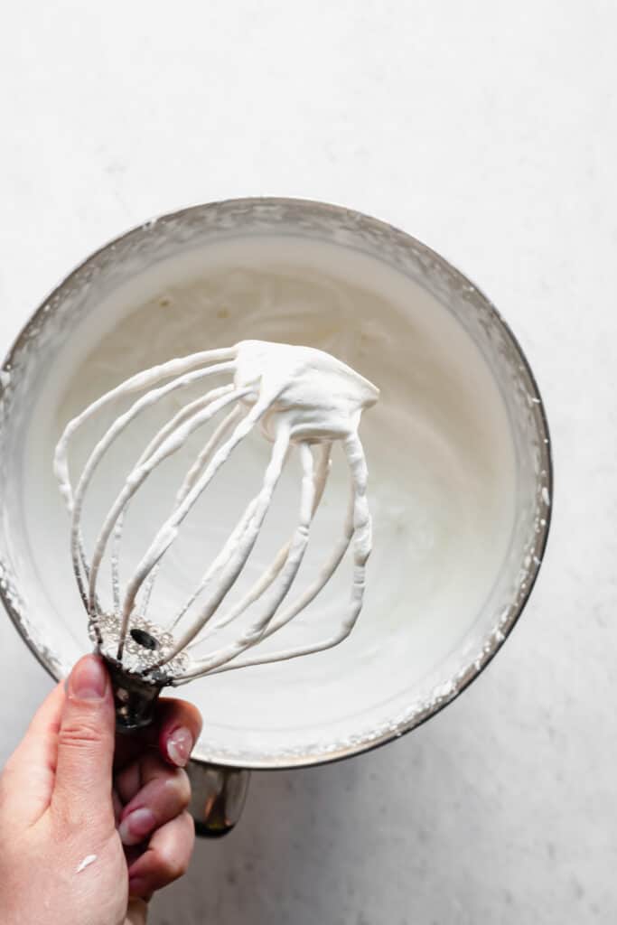 Soft peaks of heavy cream on a whisk
