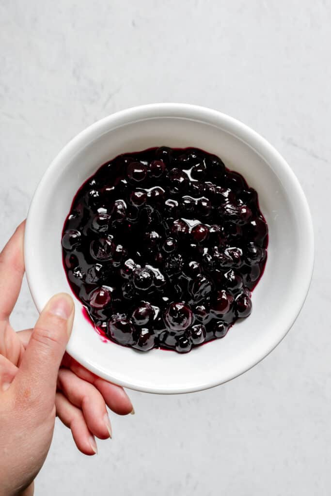 A bowl of blueberry pie filling.