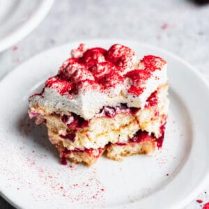 One slice of Cherry Almond Tiramisu on a plate with a bite removed.