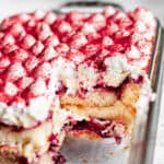 Sliced cherry almond tiramisue with pieces removed.