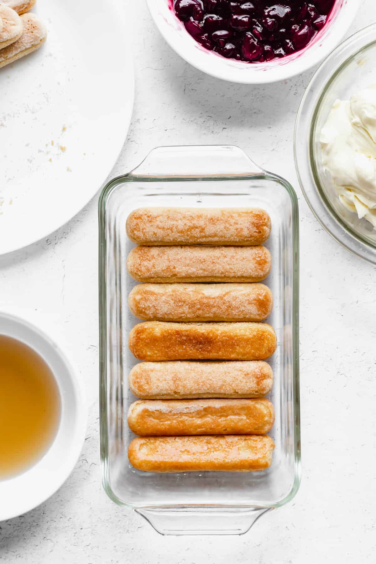 Dipped and layered lady fingers in the bottom of a loaf pan.