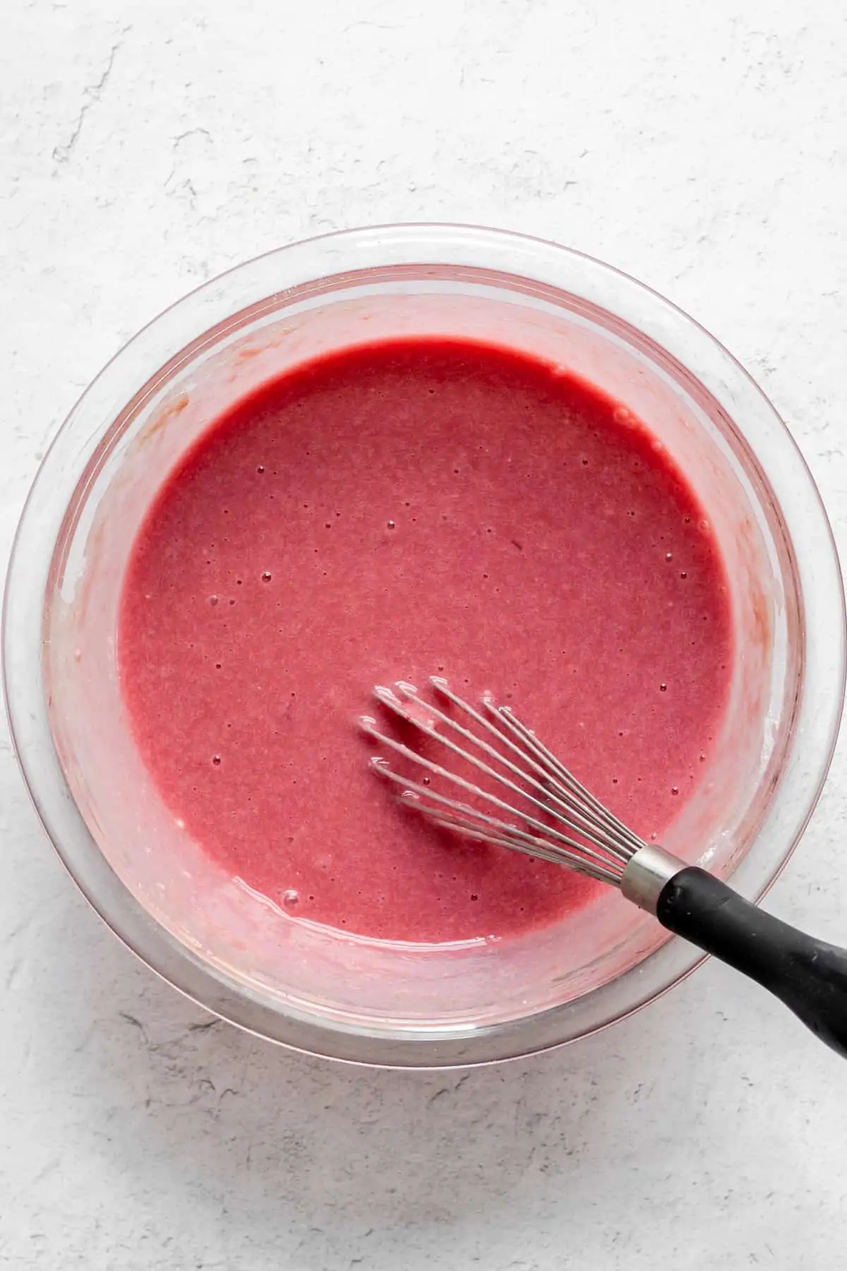 Rhubarb curd in a bowl after the food coloring is added