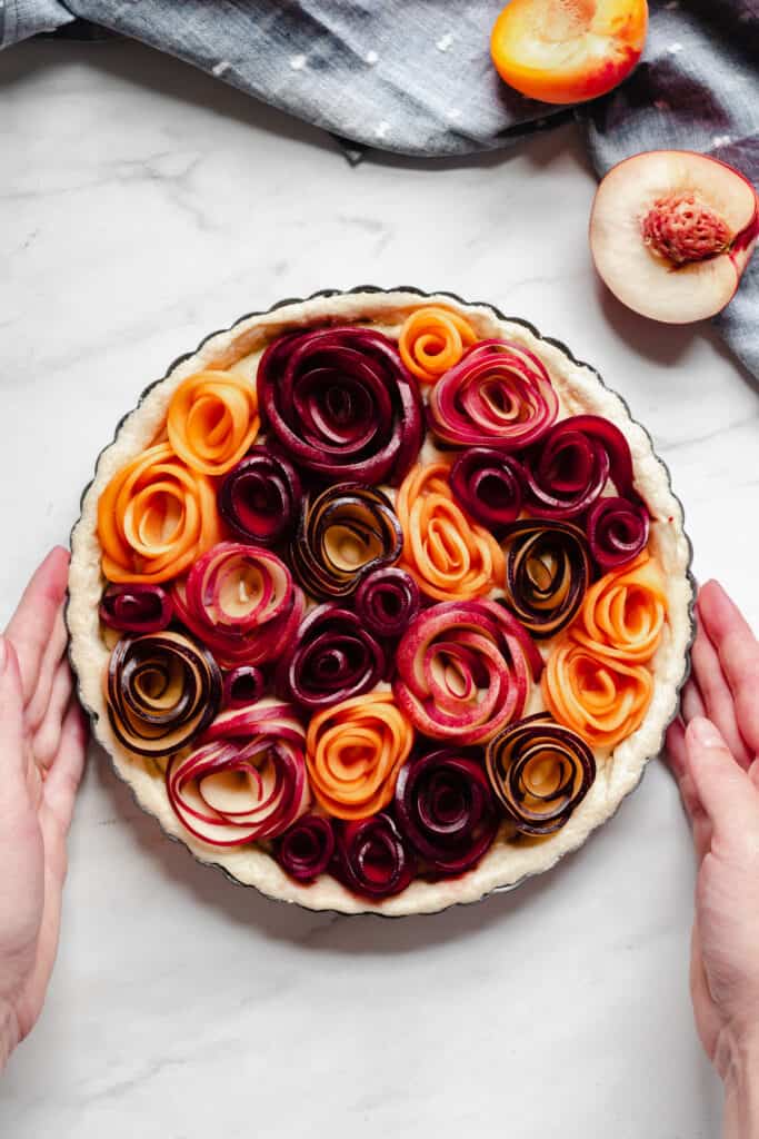 Completed stone fruit tart prior to baking, shot from overhead.