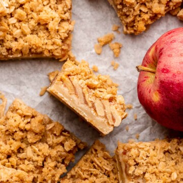 Apple crisp bars cut into squares. One lays on its side.