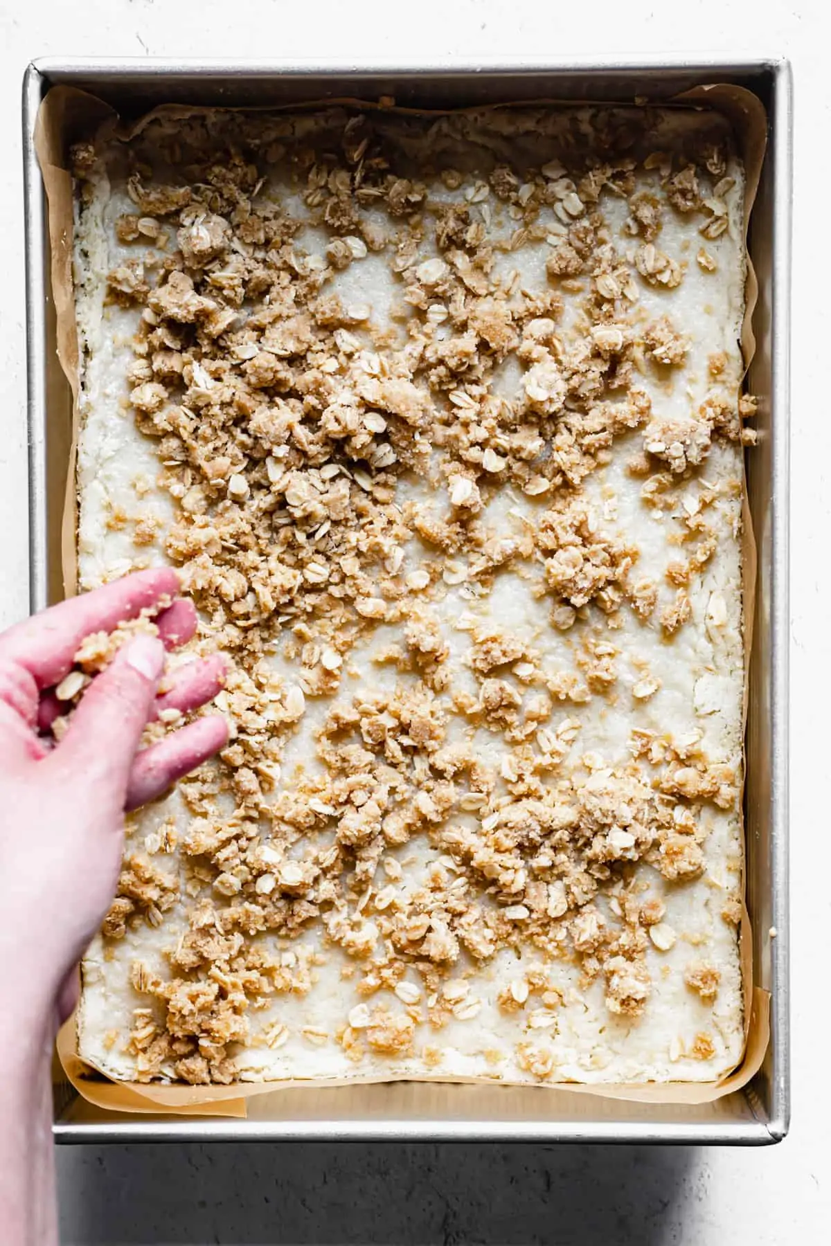 crumble topping gets scattered on the par-baked shortbread base