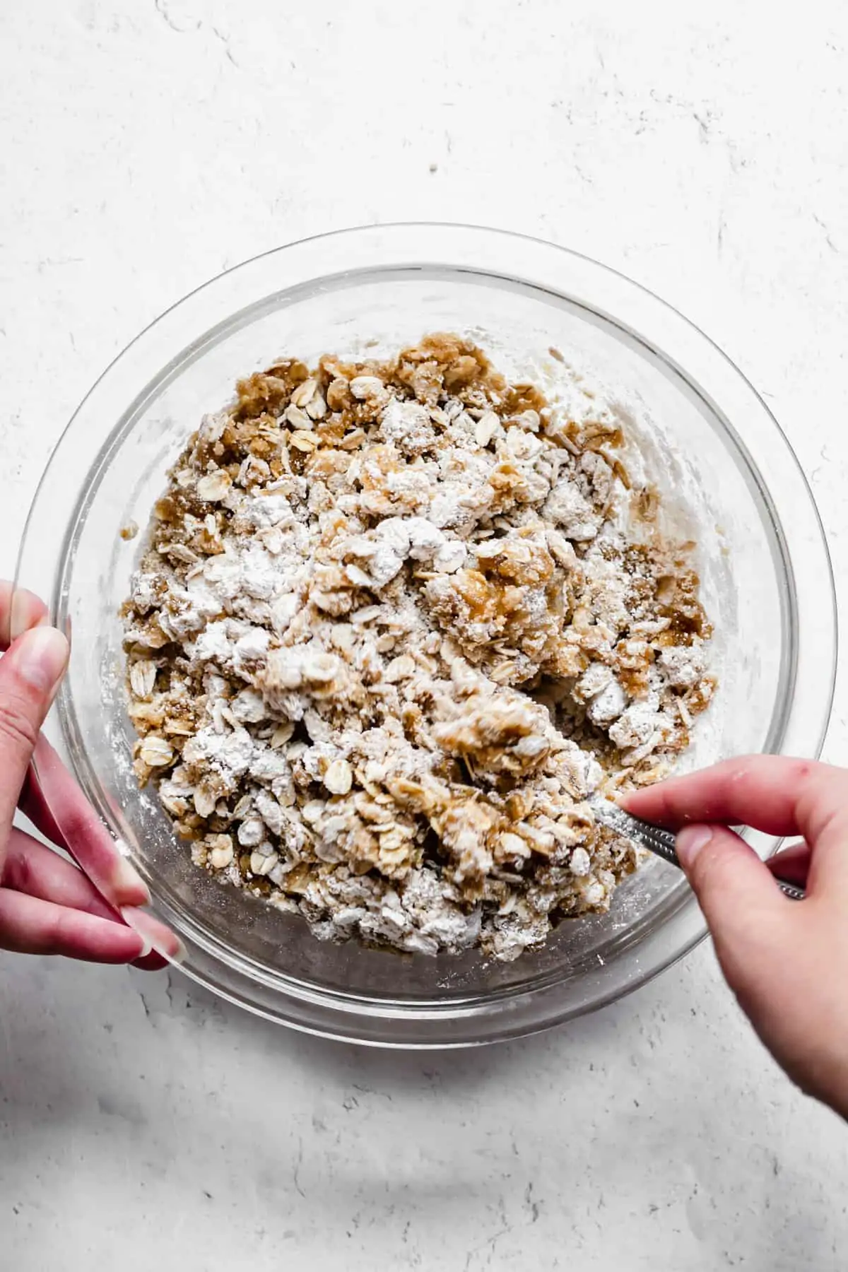 a fork stirs together the crumble topping