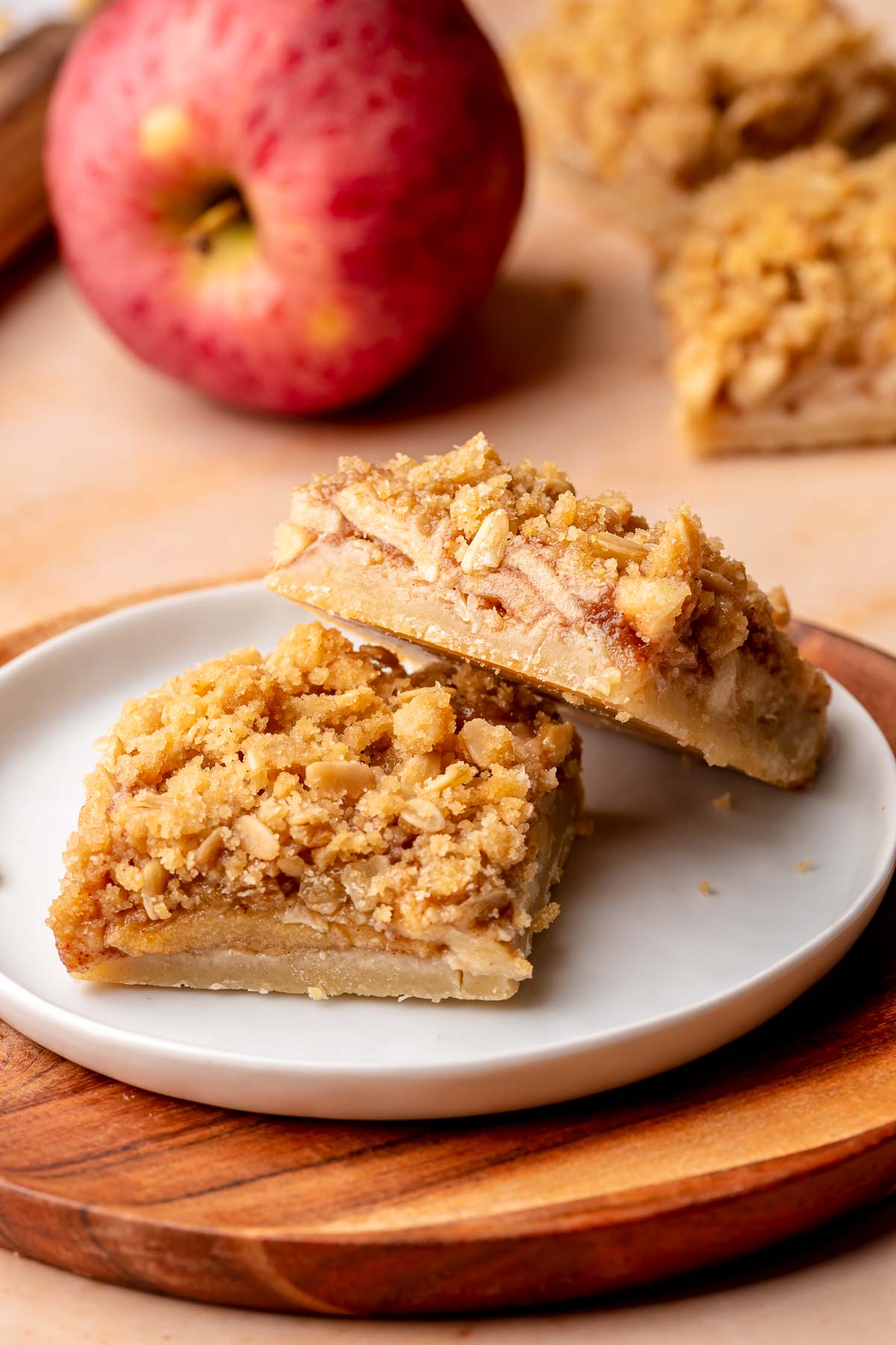 Two apple crisp bars on a plate.