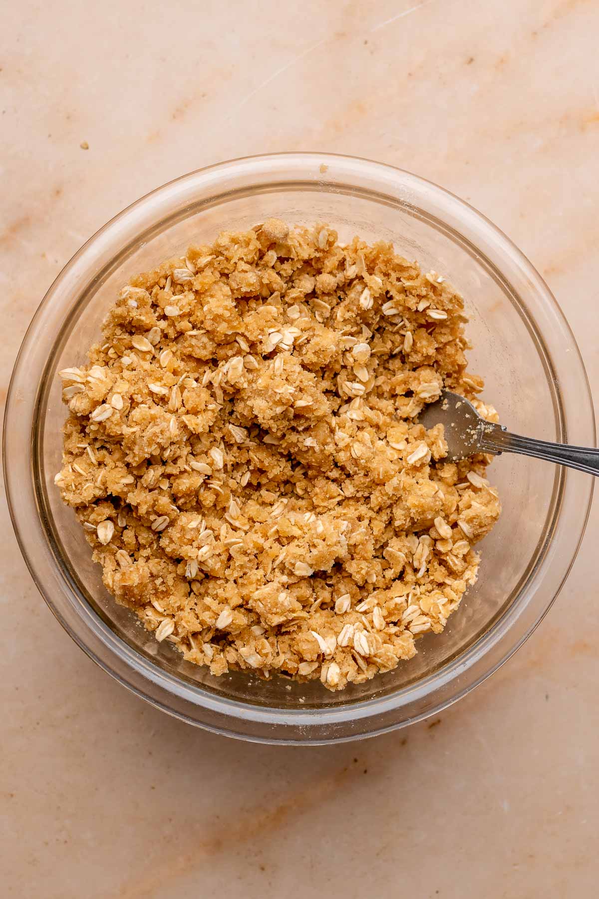Oat crumble in a bowl with a fork.