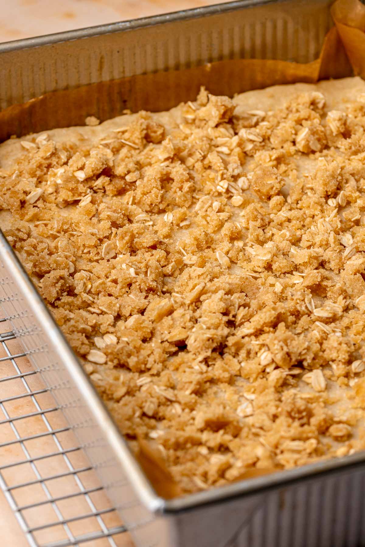 Streusel scattered on shortbread in a baking pan.