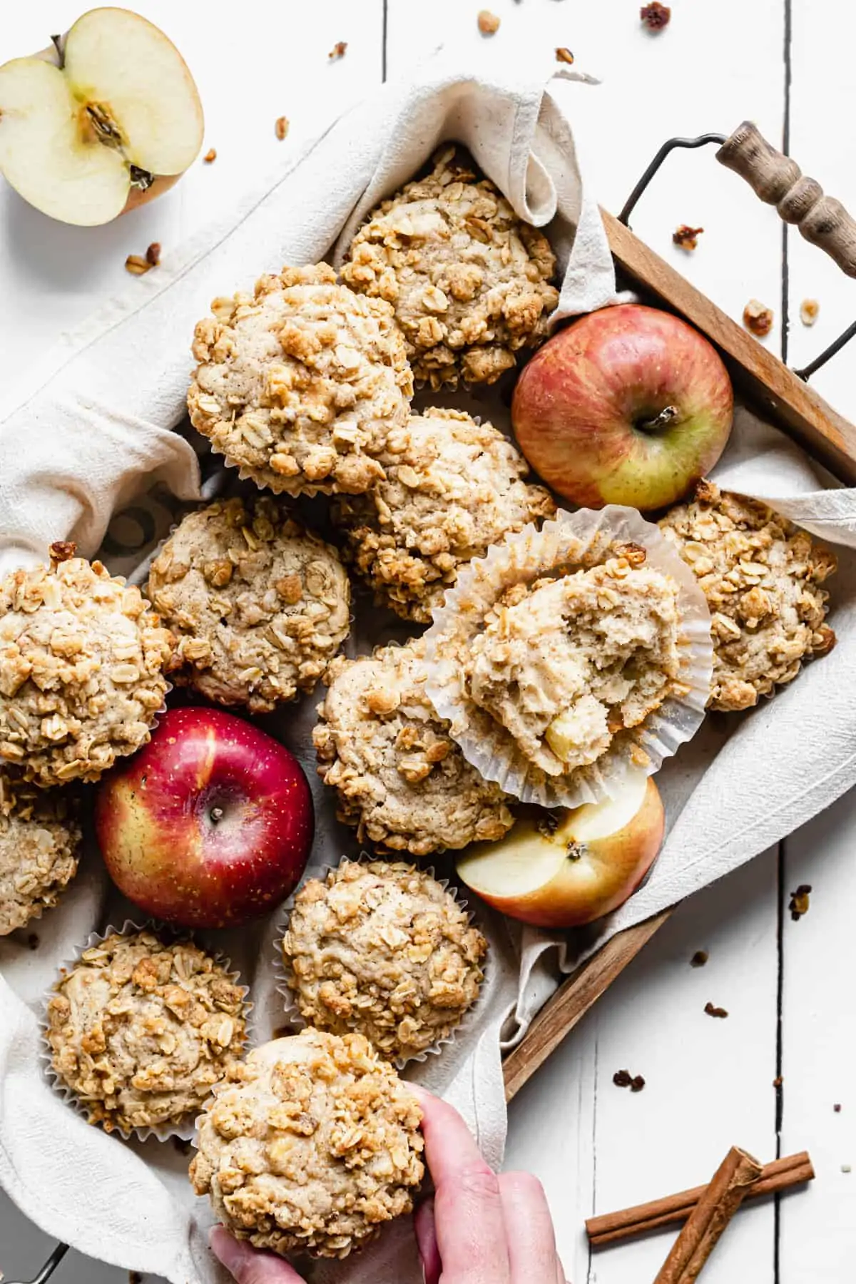 overhead shot of the muffins in a wooden box with apples