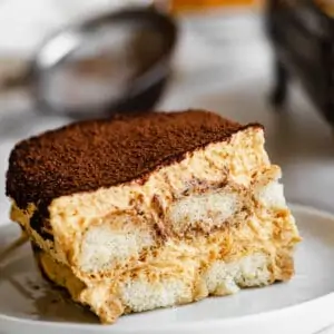 One slice of pumpkin chai tiramisu on a plate