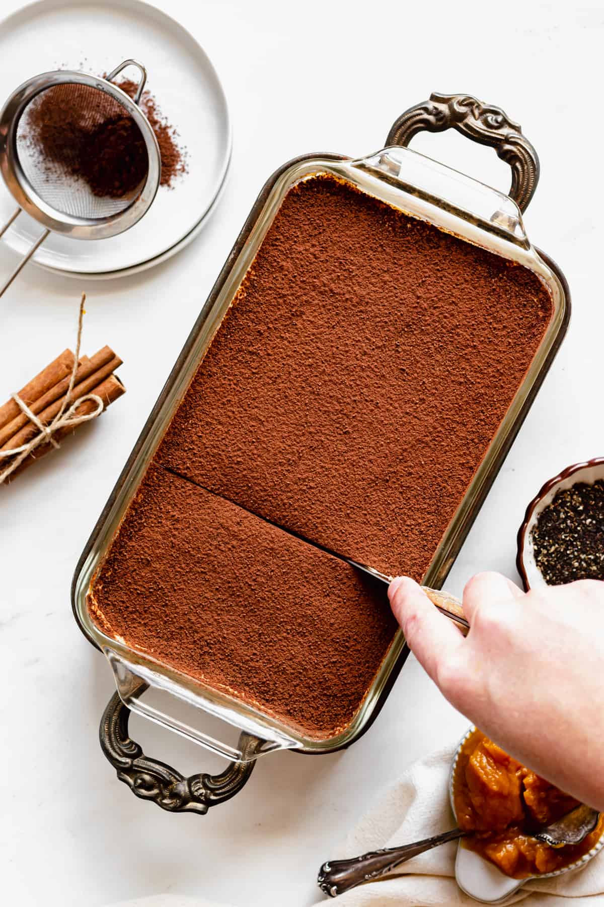 A knife cuts into the pumpkin chai tiramisu.