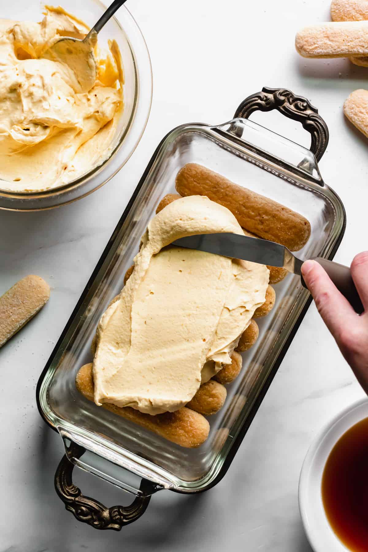 Pumpkin mascarpone mixture spread onto the first layer of lady fingers.