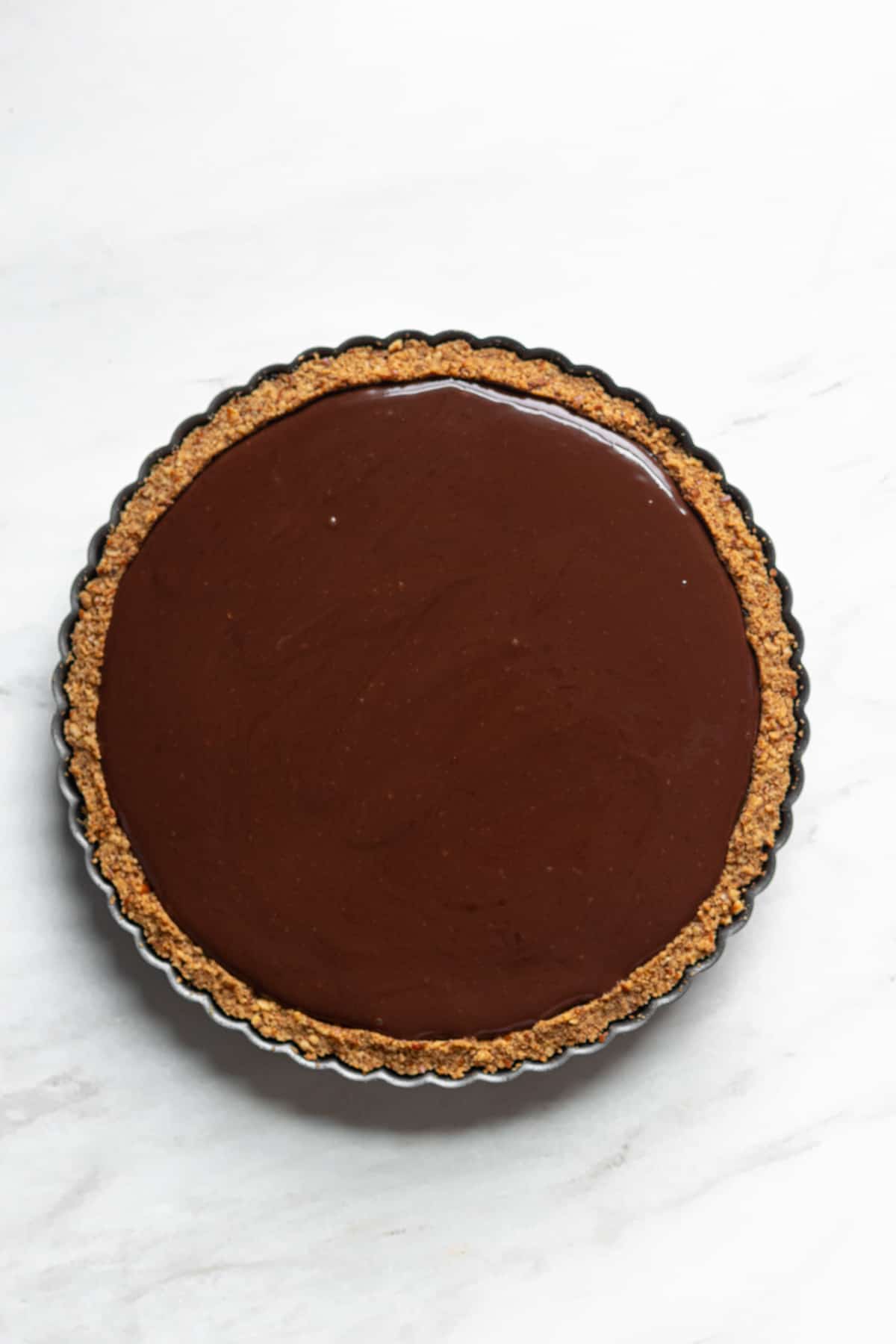 Overhead shot of chocolate ganache set on top of the pie.