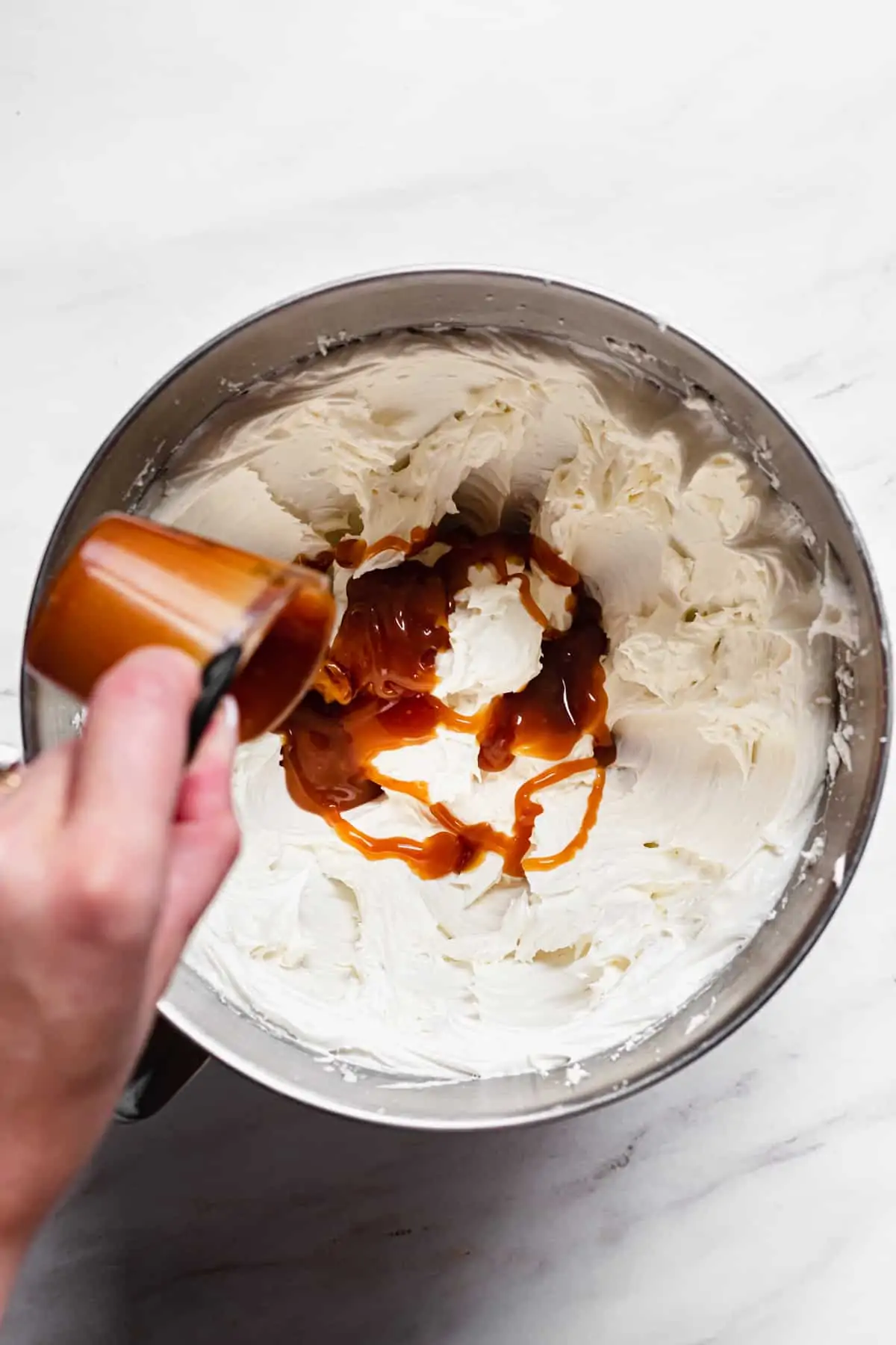 Caramel being poured into the buttercream