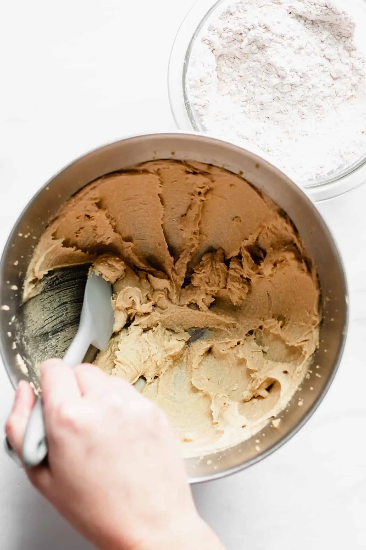 Creamed batter being scraped down.