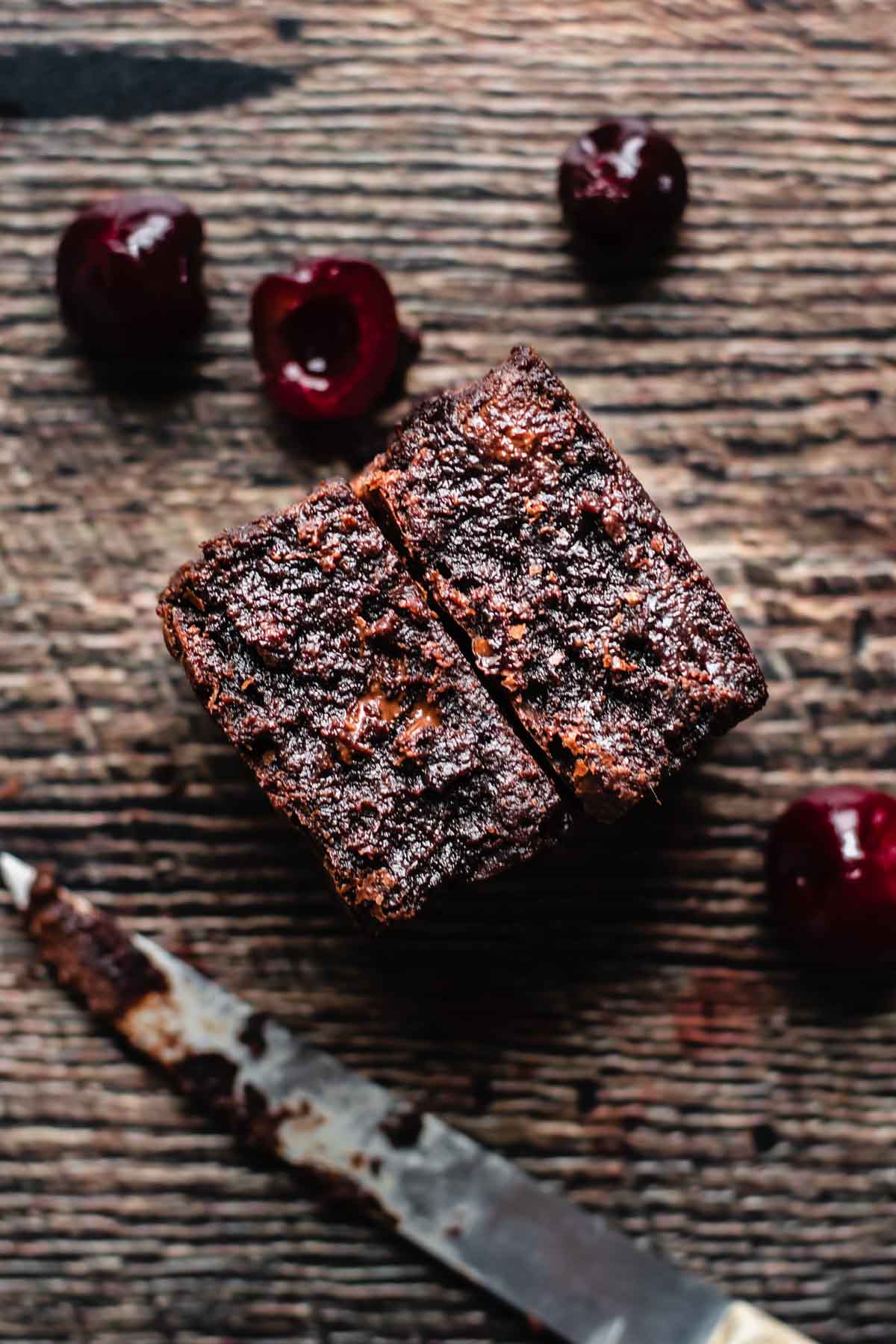 Two pieces of cherry chocolate brownies to show the insides.