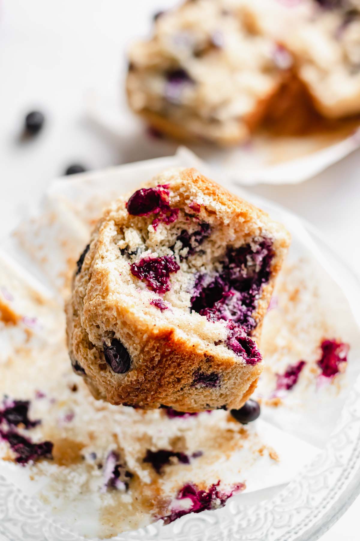 One blueberry muffin with a bite removed.
