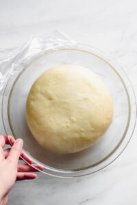 Donut dough in the bowl has doubled in size and is ready to roll out.